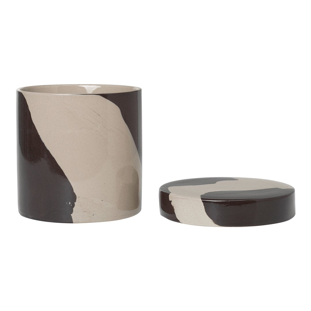 "Round decorative storage container in earthy tones of brown and beige with a sleek, modern pattern."