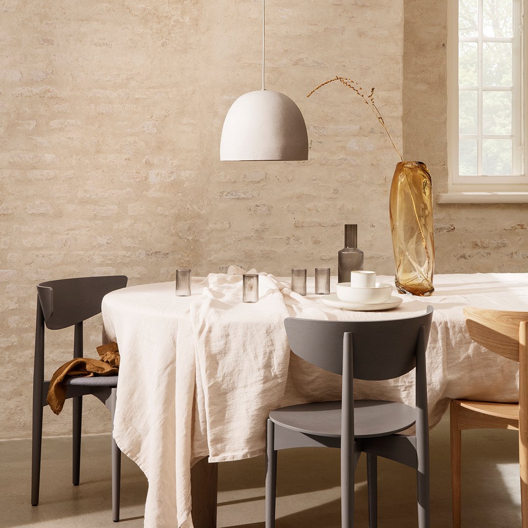 "Minimalist dining setup featuring beige, gray, and amber tones with soft textures and natural patterns."