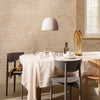 "Minimalist dining setup featuring beige, gray, and amber tones with soft textures and natural patterns."