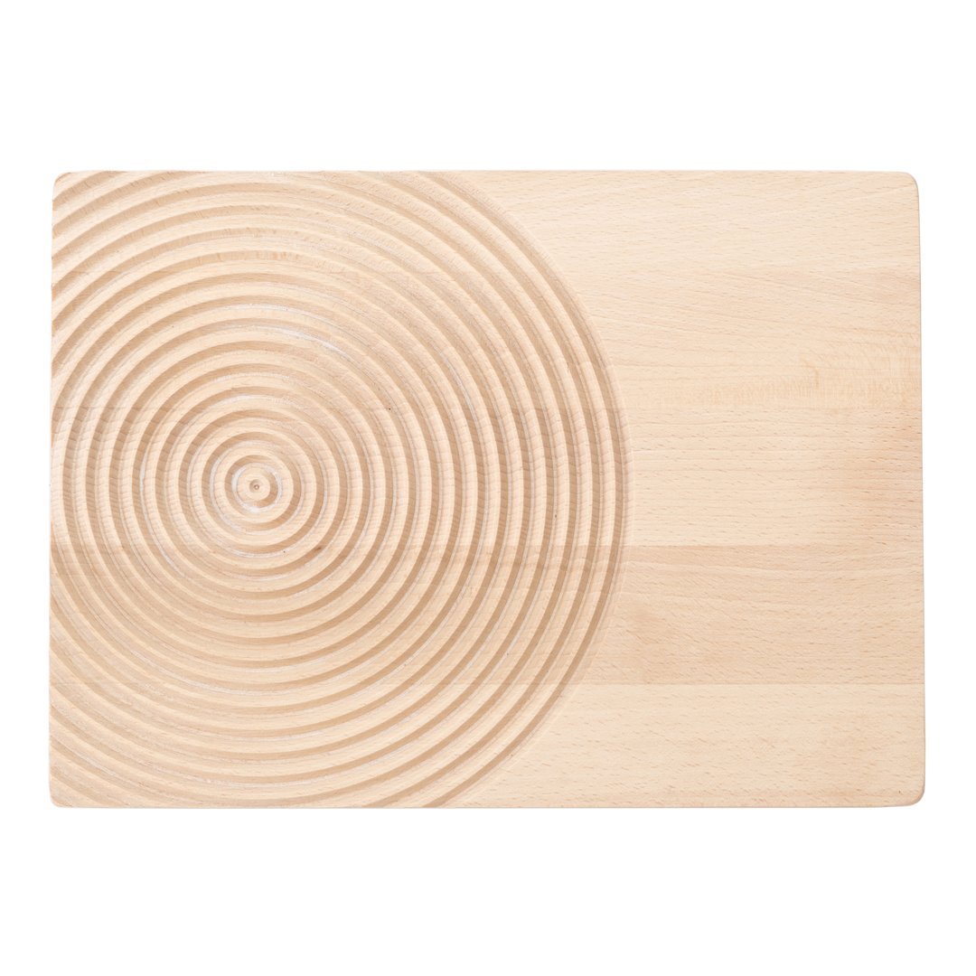 Natural wood cutting board with a smooth surface and concentric circle pattern in a light beige hue.