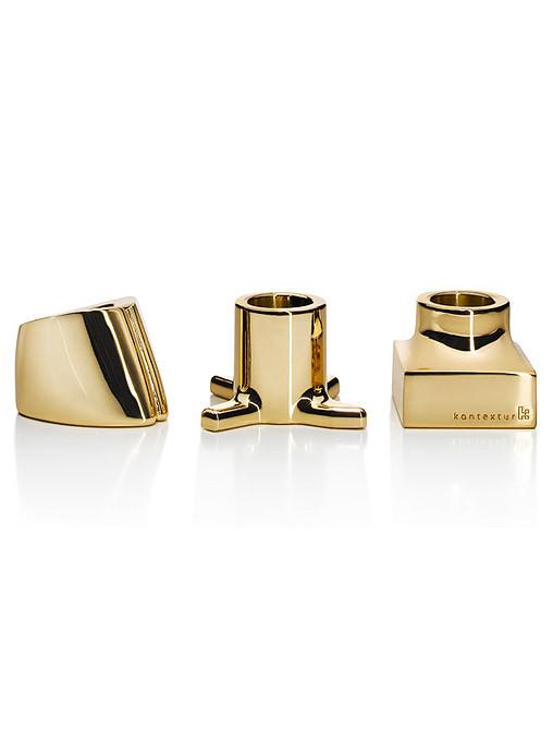 Gold geometric decorative pieces with polished surfaces and sleek lines, showcasing a modern and elegant design.
